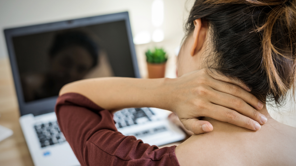 A young woman holding the back of her neck