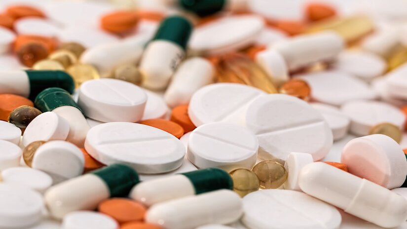 Aspirin tablets and pills scattered on a surface